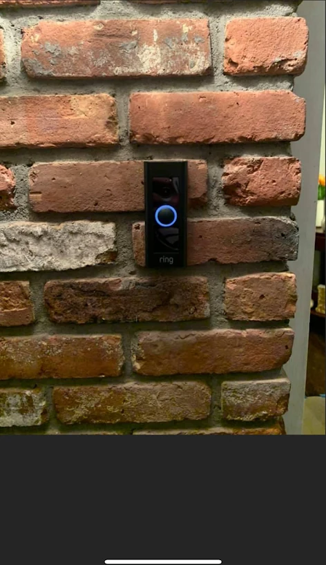 Video doorbell installed on brick