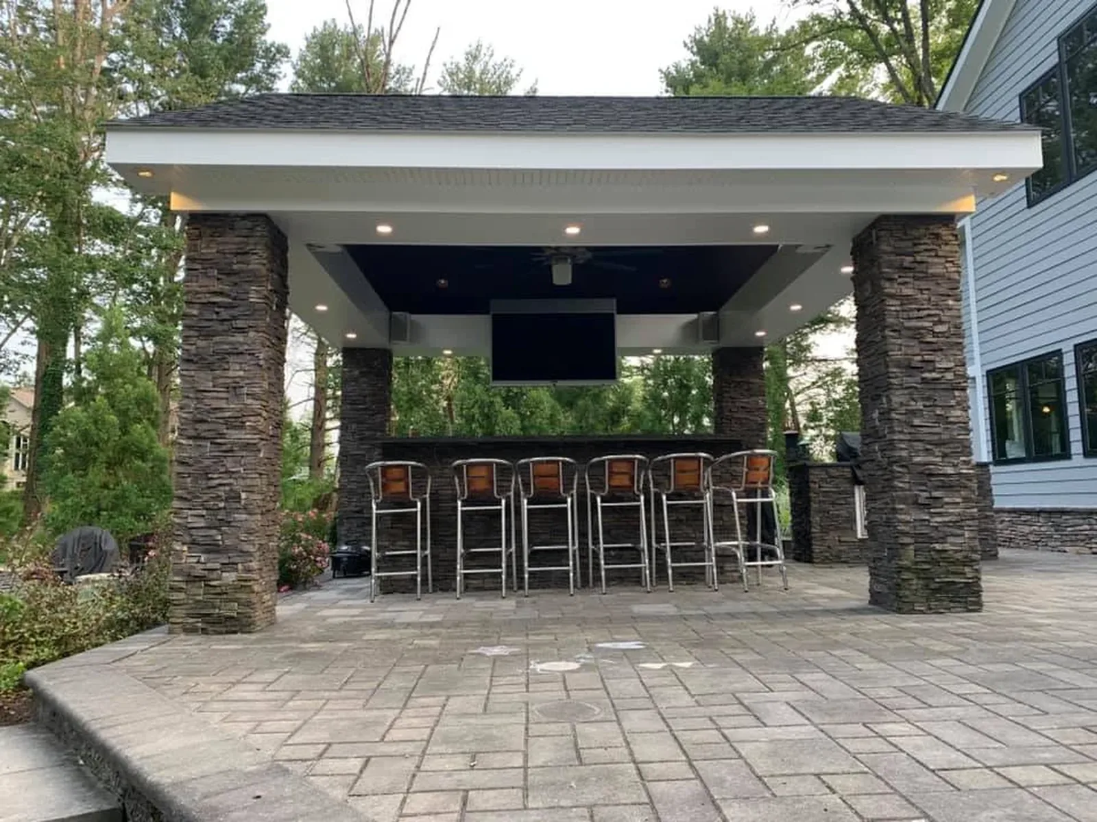 Outdoor pavilion with recessed lighting, ceiling fan and mounted TV, wired by Dombrowski Electric